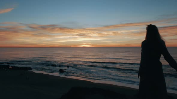 Woman Looking At The Ocean alt