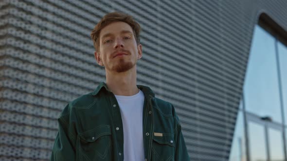 Redhead Man with Serious Facial Expression Posing Outdoors alt