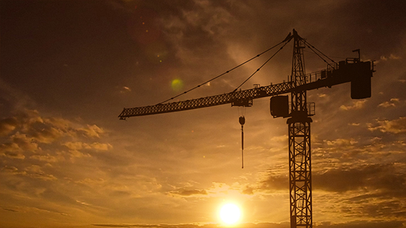Sunset And Crane Silhouette On Construction Site