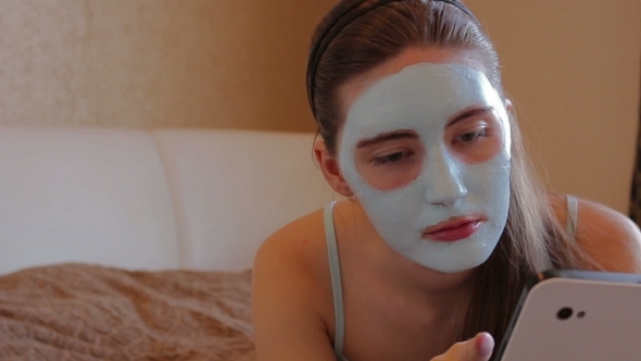 Woman With Cosmetic Mask On Her Face