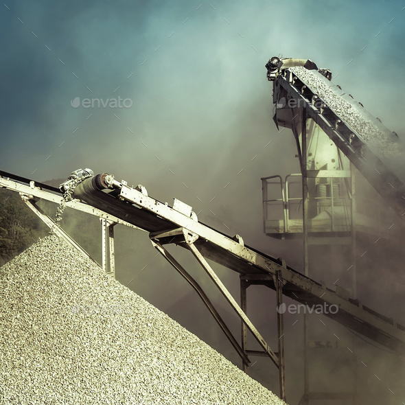 Working gravel crusher. Industrial background