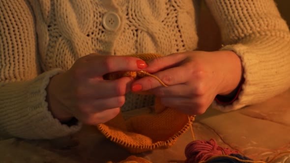 Woman Sitting and Knitting Beautiful Orange