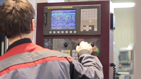 Operator Working With Control Panel Of CNC Machining Centerchanging Numbers