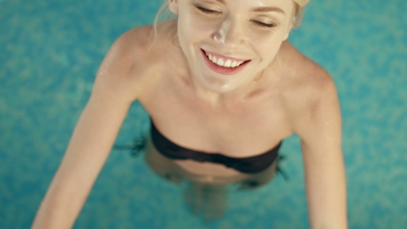 Sexy Blonde Relaxing In The Swimming Pool