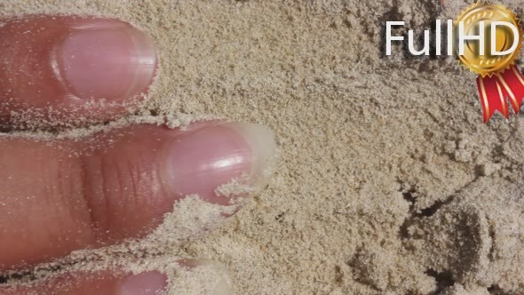 Female Hands in Beach Sand