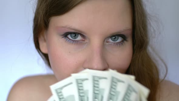 Young Woman Playing With Bunch Of Money