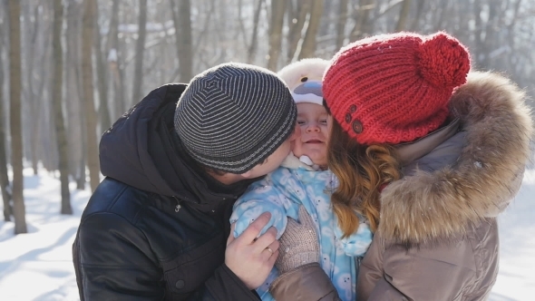Family Walking In The Winter Park