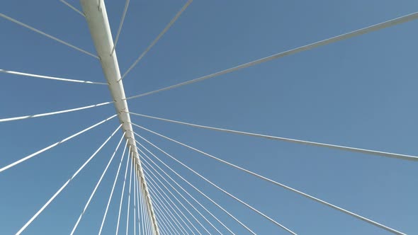 stabilized shot with movement of cables from a bridge and blue sky in the background alt