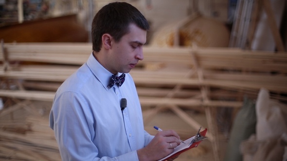 Man Writes a Pen on a Piece of Paper alt