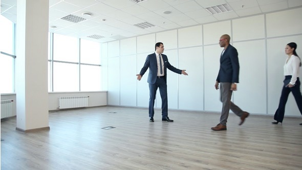 Businessman Shows the Customer a New Office Space