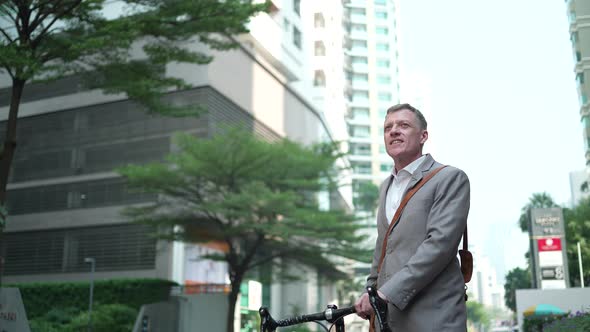 businessman with a bicycle to working in the city downtown, business work new normal urban lifestyle alt