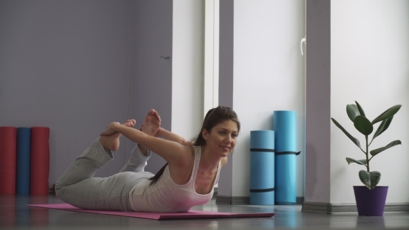 Woman Doing   Exercises For Flexibility In Gym On The Floor alt