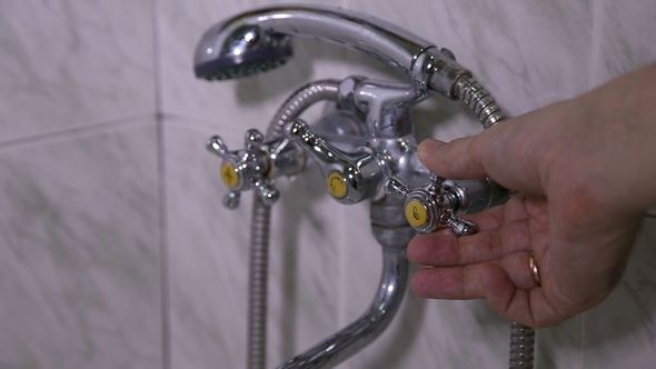 The Man Opens the Tap Water in the Bathroom alt