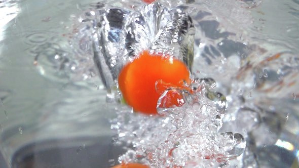 Tomatoes Falling In Water