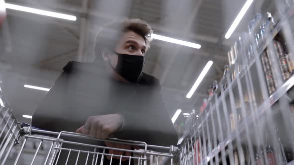 Young Attractive Man with Face Mask Standing in Supermarket alt