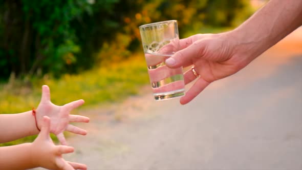The Child Drinks Water From a Glass alt