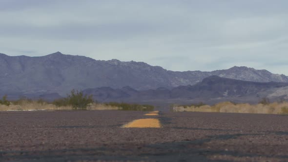 Male running along road in the desert alt