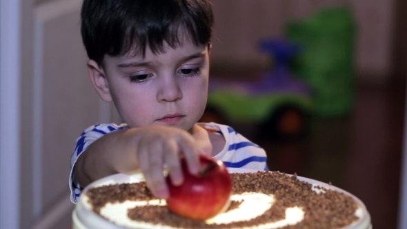 Cheerful Boy Playing With  Red Apples.