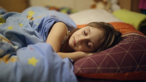 The Girl is Lying in Bed Before Going to Sleep alt