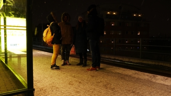 Group Of Friends Waiting For Subway, Night alt