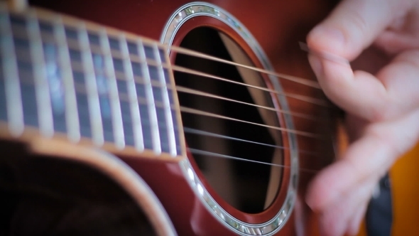 Southpaw Man With Tatoo Playing Acoustic Guitar