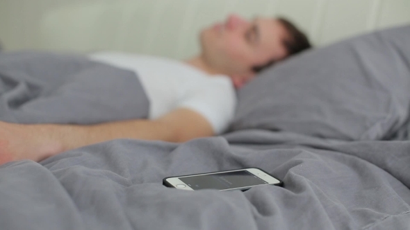 Man Turns Off The Alarm On The Phone
