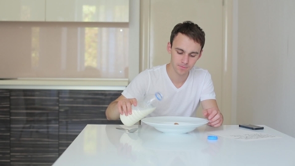 Man Pours Milk In a Bowl