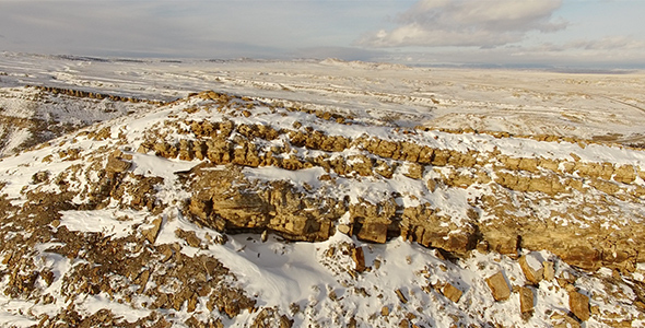 Low Flyover of Snow Covered Cliff Face alt