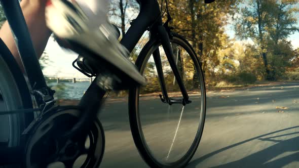 Gear System Road Bicycle And Bike Wheel Rotation.Cyclist Legs Twist Pedals And Riding Triathlon Road alt