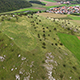 Aerial Footage of a Model Airplane on a Green Hill - VideoHive Item for Sale
