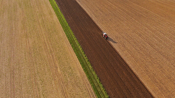 Aerial Footage of a Tractor on a Field