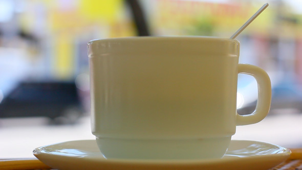 Coffee Cup In Street Restaurant With City Background