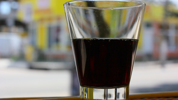 Glass Of Soda Beverage With City Street Background