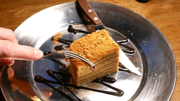 Cake Being Cut With Fork And Knife