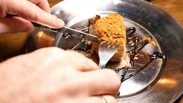 Cake Being Cut With Fork And Knife.  Shot.