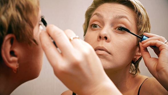 Pretty Blond Woman Applying Mascara Make-up