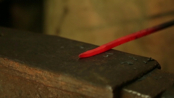 Farrier Hammers On The Red-Hot Piece Of Iron