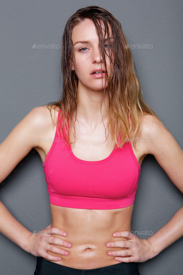 Beautiful Young Woman in Pink Sports Bra Running Stock Photo