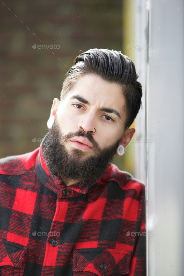 Gangster with beard and piercings Stock Photo by mimagephotography