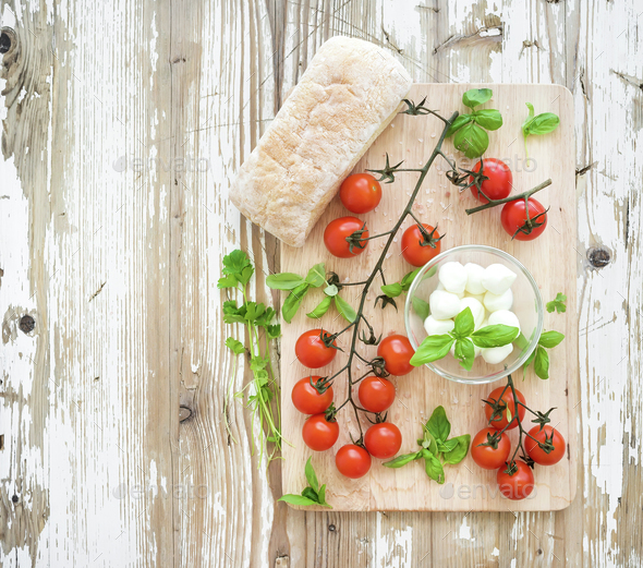 Ciabatta bread with banch of cherry-tomatoes, basil and mozzarella cheese - Stock Photo - Images