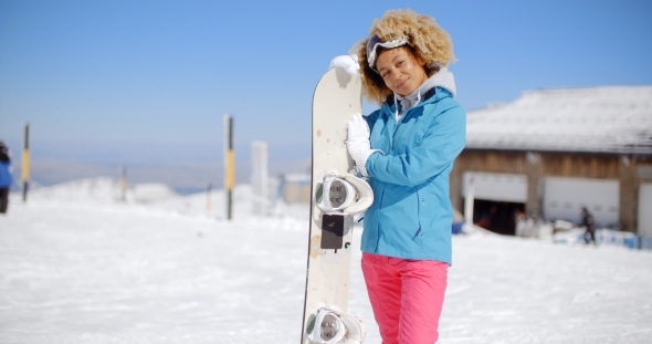 Attractive Young Woman Posing At a Ski Resort alt
