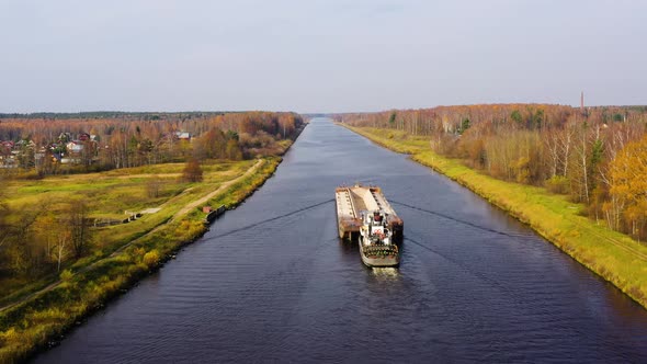 Aerial view:Barge on the River. Autumn Landscape, River Canal Near the Forest. alt
