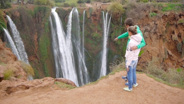 Woman And Man Looking Waterfall. Filmed In Morocco Near Ouzoud Waterfall alt
