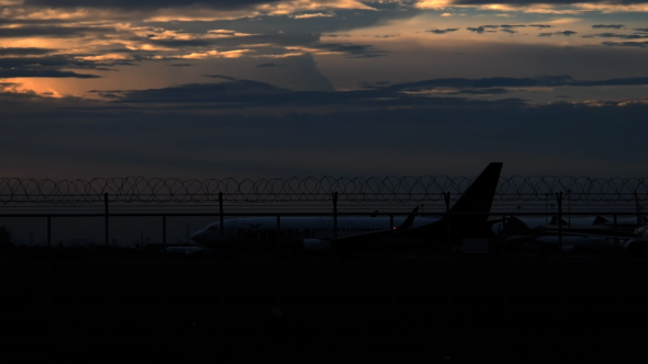 Airplane In Airport At Evening alt