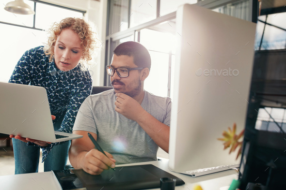 Two designers working in their office - Stock Photo - Images