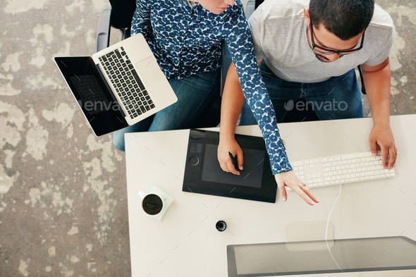 Young graphic designers coworking in office - Stock Photo - Images