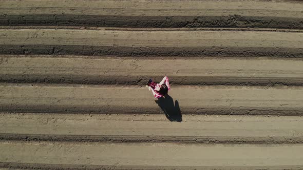 Aero. Female Farmer, Agronomist Is on Field with Special Soil Rows. She Tests, Using Tablet alt