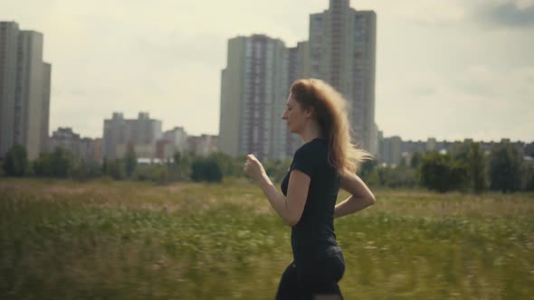 Running Woman Workout. Fit Woman Cardio Training. Runner Workout On Grass Field. Endurance Jog. alt