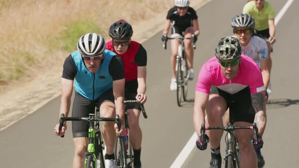 Group of cyclists on road.  Fully released for commercial use.