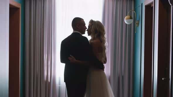 Cute Couple Silhouettes of Bride and Groom Hug By Window alt